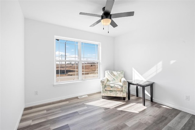 unfurnished room with ceiling fan, baseboards, and wood finished floors