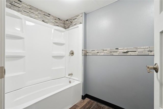 full bathroom with bathtub / shower combination, baseboards, and wood finished floors