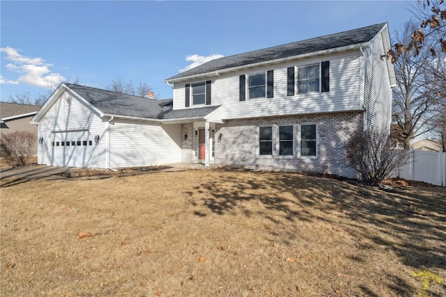 colonial home featuring driveway, a front lawn, fence, an attached garage, and brick siding