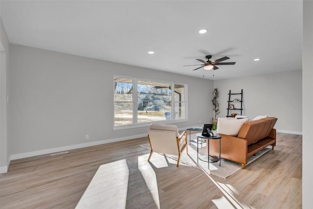 sitting room with light wood finished floors, baseboards, a ceiling fan, and recessed lighting