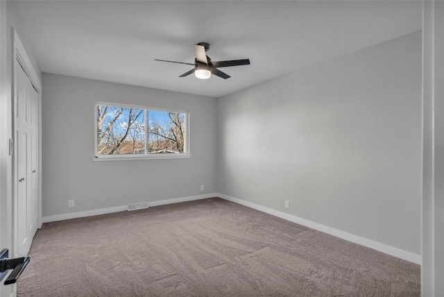 unfurnished bedroom featuring a closet, carpet, visible vents, and baseboards