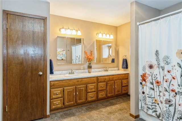 full bath featuring a sink, a shower with curtain, and double vanity