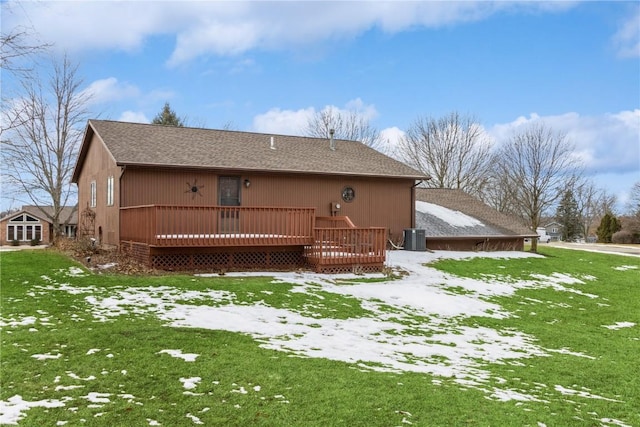 rear view of property featuring a deck, a yard, cooling unit, and roof with shingles