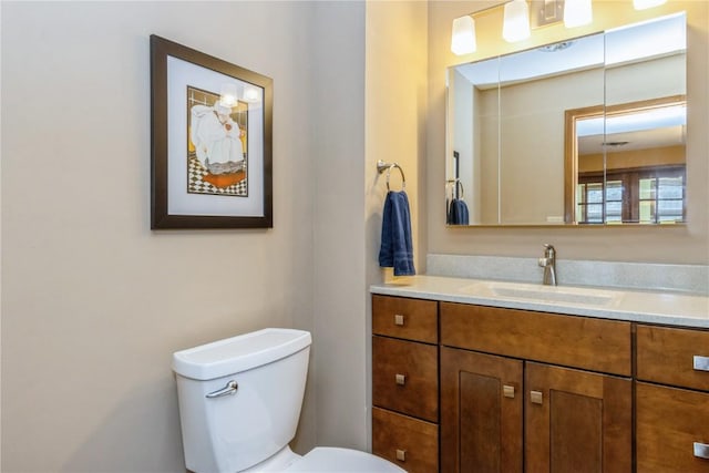 bathroom with toilet and vanity