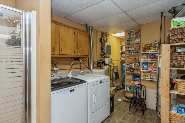 clothes washing area featuring electric panel, laundry area, washer and dryer, and tile patterned floors