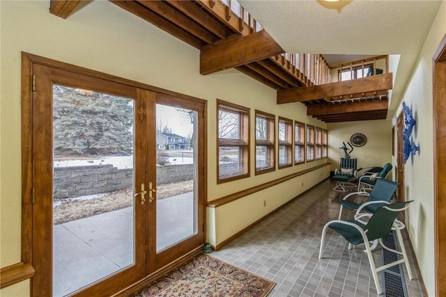 sunroom / solarium with beamed ceiling and french doors