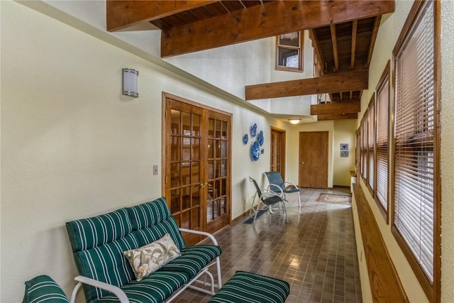 interior space featuring beamed ceiling and french doors