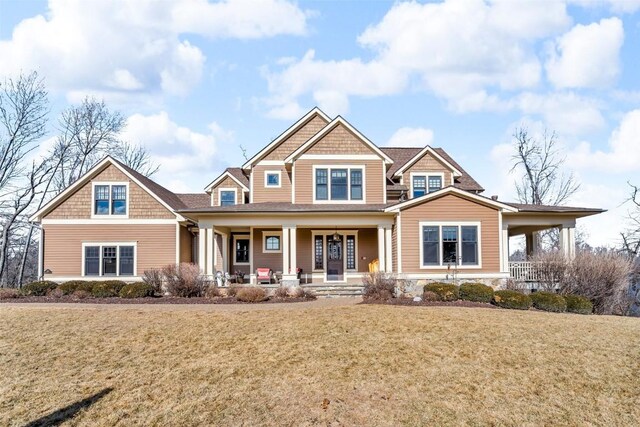 craftsman house with a porch and a front yard