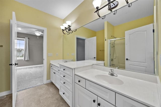 full bath with tile patterned floors, baseboards, an enclosed shower, and vanity