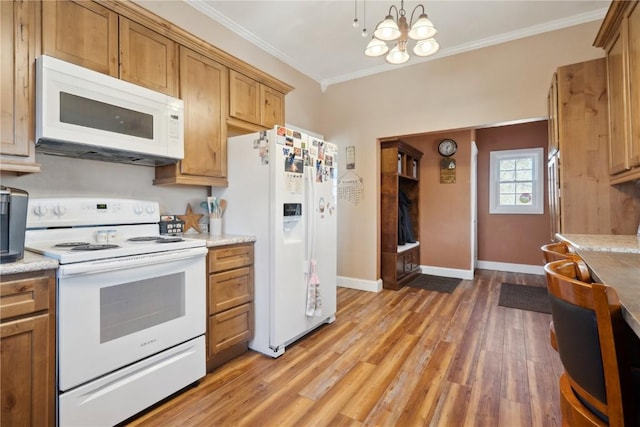 kitchen featuring ornamental molding, white appliances, light countertops, and light wood-style floors