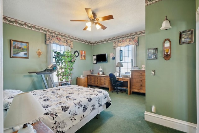 bedroom featuring ceiling fan, a textured ceiling, baseboards, and carpet flooring