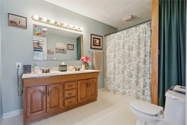 full bath with double vanity, visible vents, toilet, a sink, and a textured ceiling