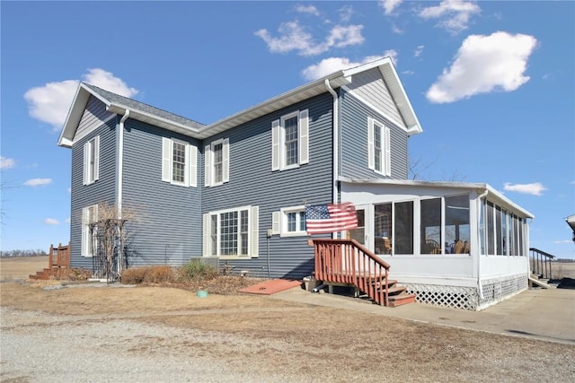 exterior space with entry steps and a sunroom