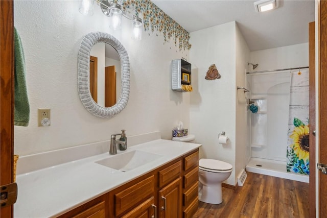 full bathroom with visible vents, a shower with shower curtain, toilet, vanity, and wood finished floors