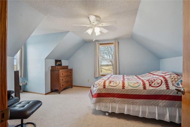 bedroom featuring a textured ceiling, lofted ceiling, carpet flooring, a ceiling fan, and baseboards