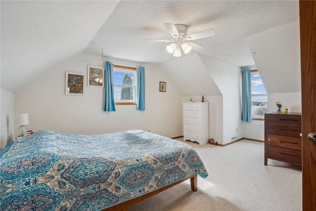 carpeted bedroom with lofted ceiling, ceiling fan, a textured ceiling, and baseboards