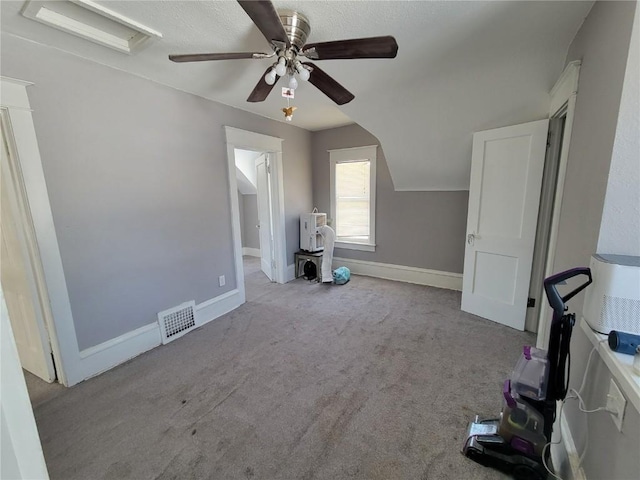 unfurnished bedroom featuring a ceiling fan, baseboards, visible vents, and carpet flooring