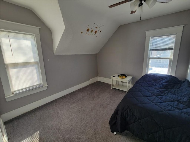 carpeted bedroom featuring vaulted ceiling, ceiling fan, and baseboards