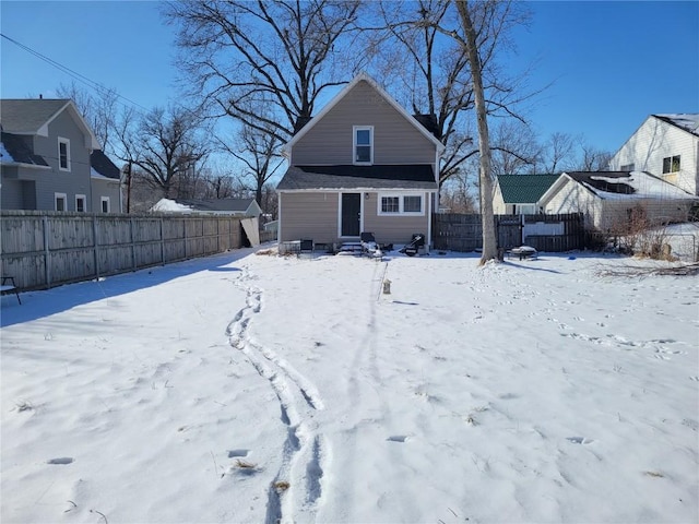 snow covered property with fence private yard