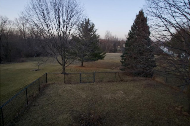 view of yard with a rural view and fence