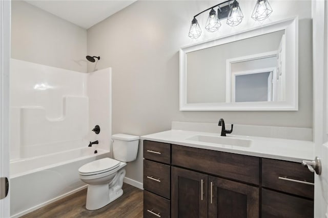 bathroom featuring vanity, shower / bath combination, wood finished floors, and toilet