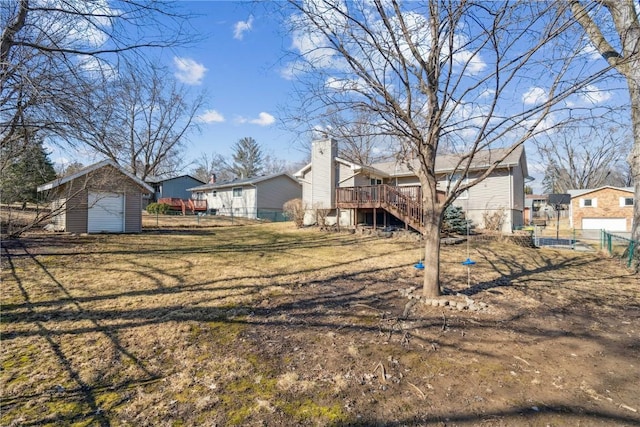 exterior space featuring a deck, a storage shed, an outdoor structure, fence, and stairs