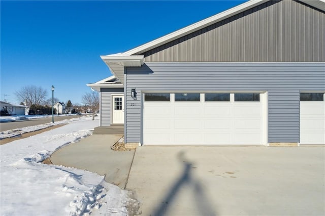 exterior space featuring concrete driveway and an attached garage