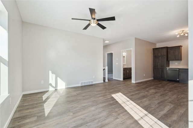 unfurnished living room featuring visible vents, baseboards, and wood finished floors