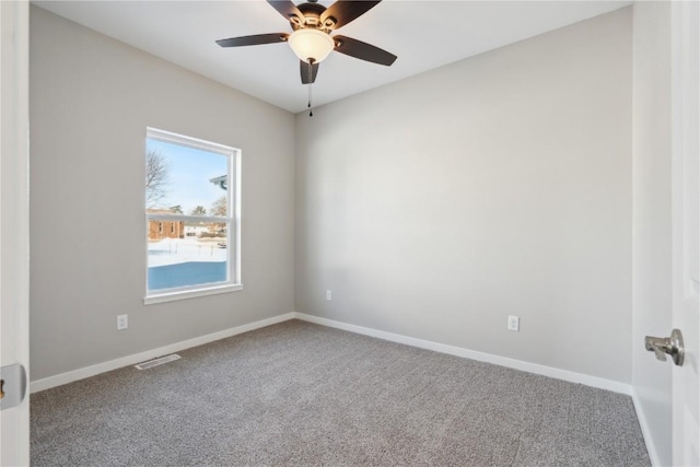 empty room featuring a ceiling fan, carpet flooring, visible vents, and baseboards