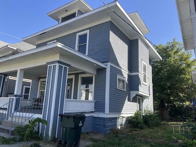 view of property exterior with a porch