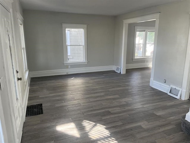 interior space featuring dark wood finished floors, visible vents, and baseboards