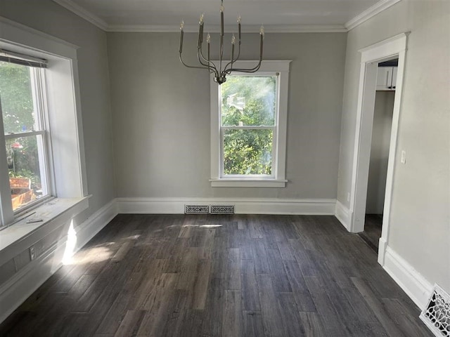 unfurnished dining area featuring dark wood-style floors, visible vents, crown molding, and a notable chandelier