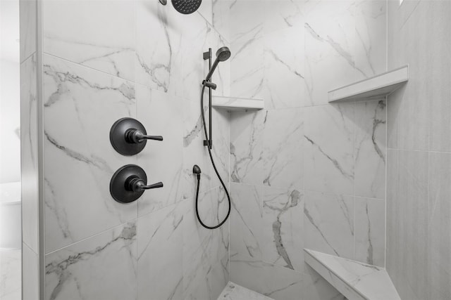 full bathroom with a marble finish shower