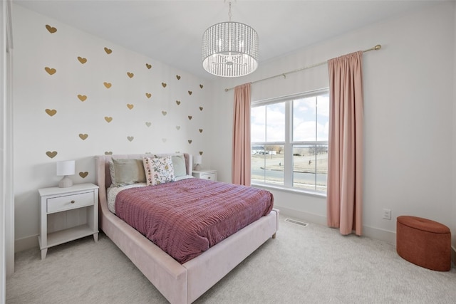 bedroom featuring a chandelier, light colored carpet, visible vents, and baseboards