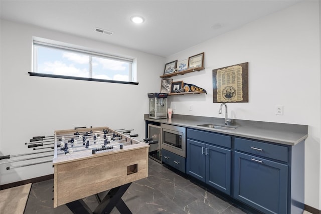 interior space with marble finish floor, visible vents, a sink, and recessed lighting