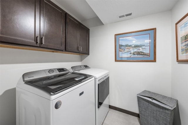 laundry room featuring visible vents, cabinet space, baseboards, and separate washer and dryer