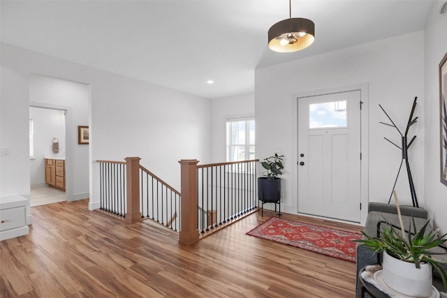 entryway with light wood-style flooring, baseboards, and recessed lighting