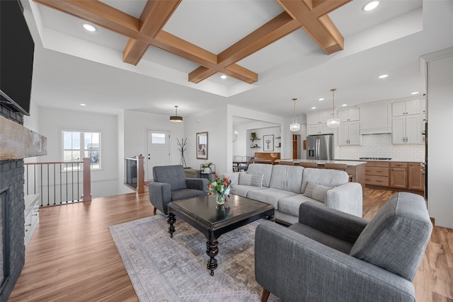 living room featuring recessed lighting, coffered ceiling, beamed ceiling, and light wood-style flooring