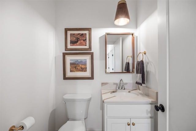 half bathroom with toilet and vanity