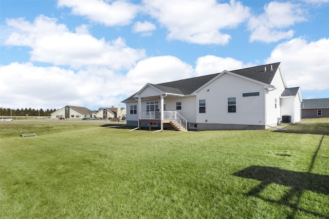 back of house featuring a lawn and cooling unit