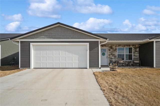 ranch-style house featuring a front lawn, stone siding, an attached garage, and concrete driveway