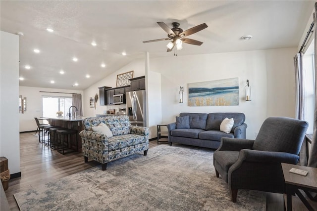 living area featuring ceiling fan, recessed lighting, vaulted ceiling, and wood finished floors