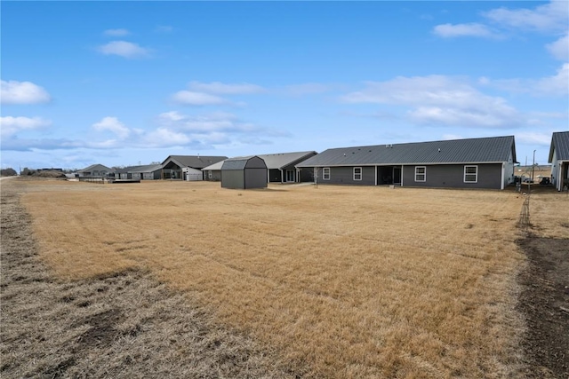 view of yard featuring a storage unit and an outbuilding