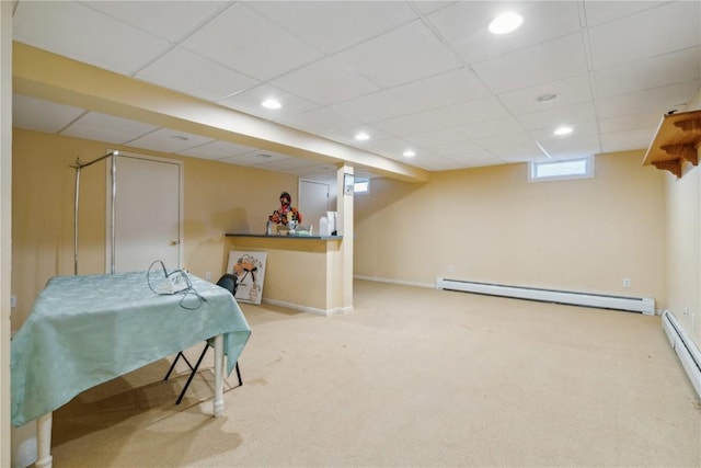 interior space featuring recessed lighting, a baseboard heating unit, carpet flooring, a drop ceiling, and baseboards