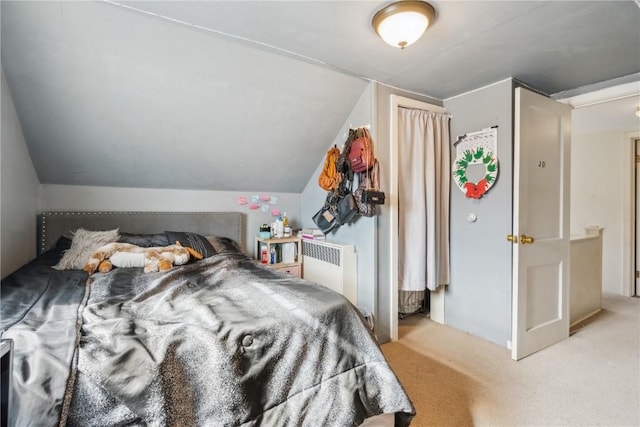 bedroom with radiator, light carpet, and vaulted ceiling