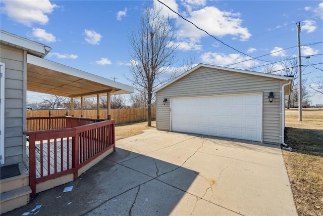 detached garage featuring fence