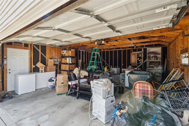 garage featuring a garage door opener and refrigerator