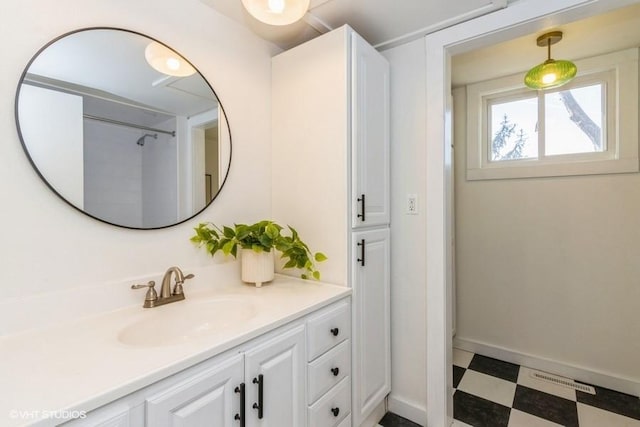 bathroom with baseboards, visible vents, vanity, and tile patterned floors