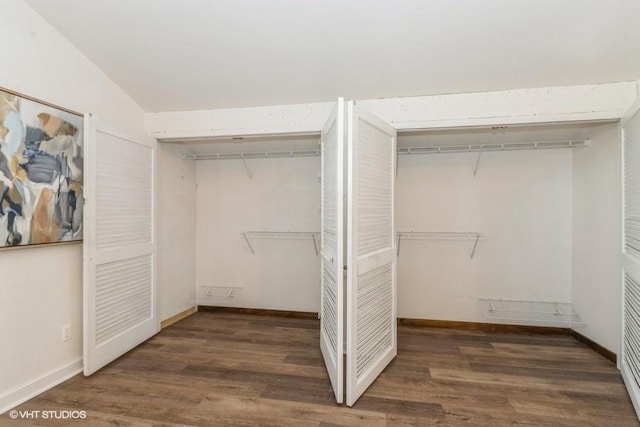 walk in closet with wood finished floors