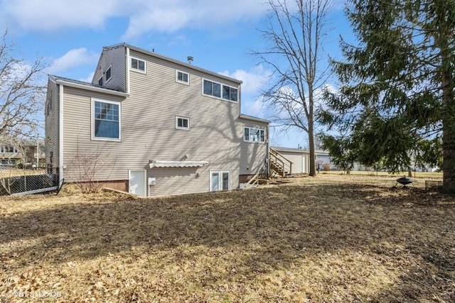 rear view of house featuring fence